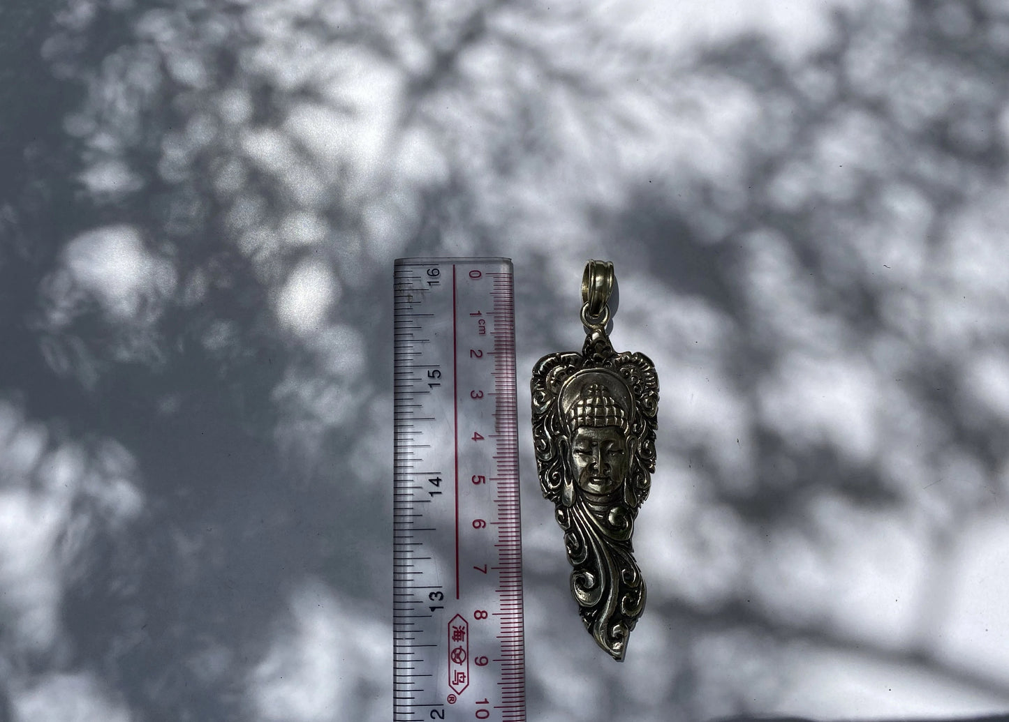 Buddha Face with Intricate Floral Motifs, Artistic Tibetan Silver Pendant.