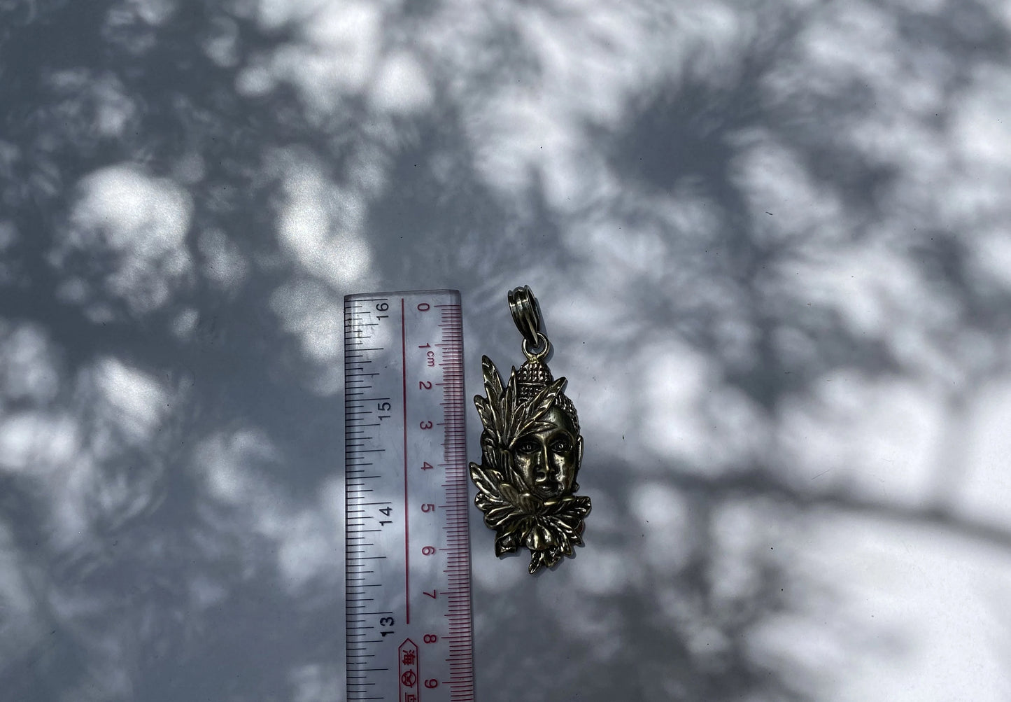 Buddha's Blooms: Floral Design Carved Tibetan Silver Buddha Face Pendant, Tibetan Silver Pendant with Buddha Face and Floral Motifs