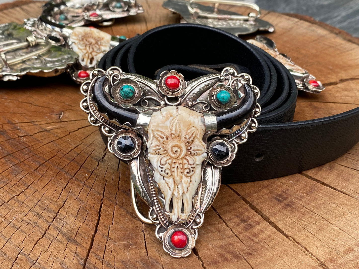 Bulls head shaped Tibetan Silver Belt Buckle adorned with Natural Turquoise, Red Coral, Black Onyx. Floral Design carved on buffalo bone.
