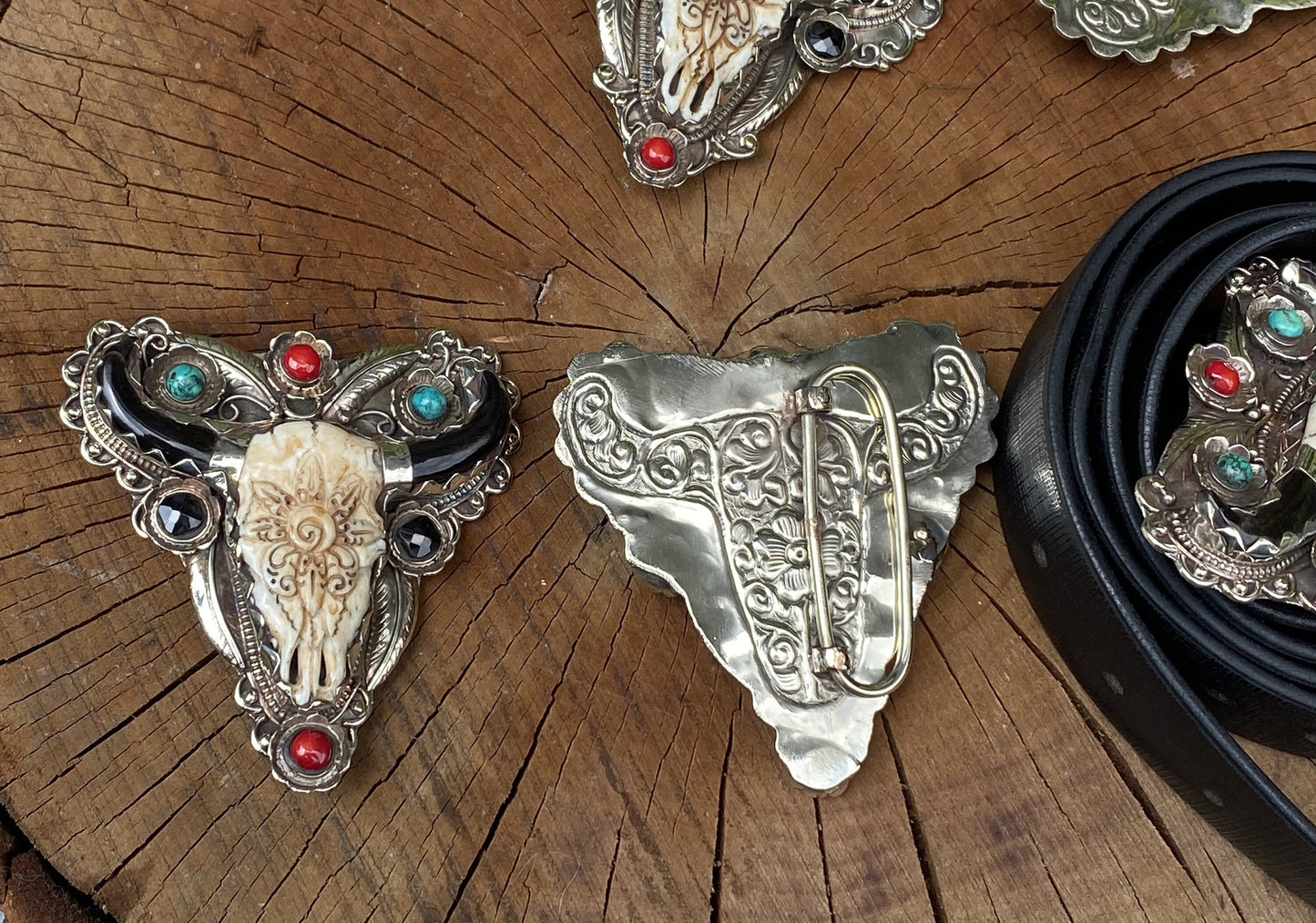 Bulls head shaped Tibetan Silver Belt Buckle adorned with Natural Turquoise, Red Coral, Black Onyx. Floral Design carved on buffalo bone.