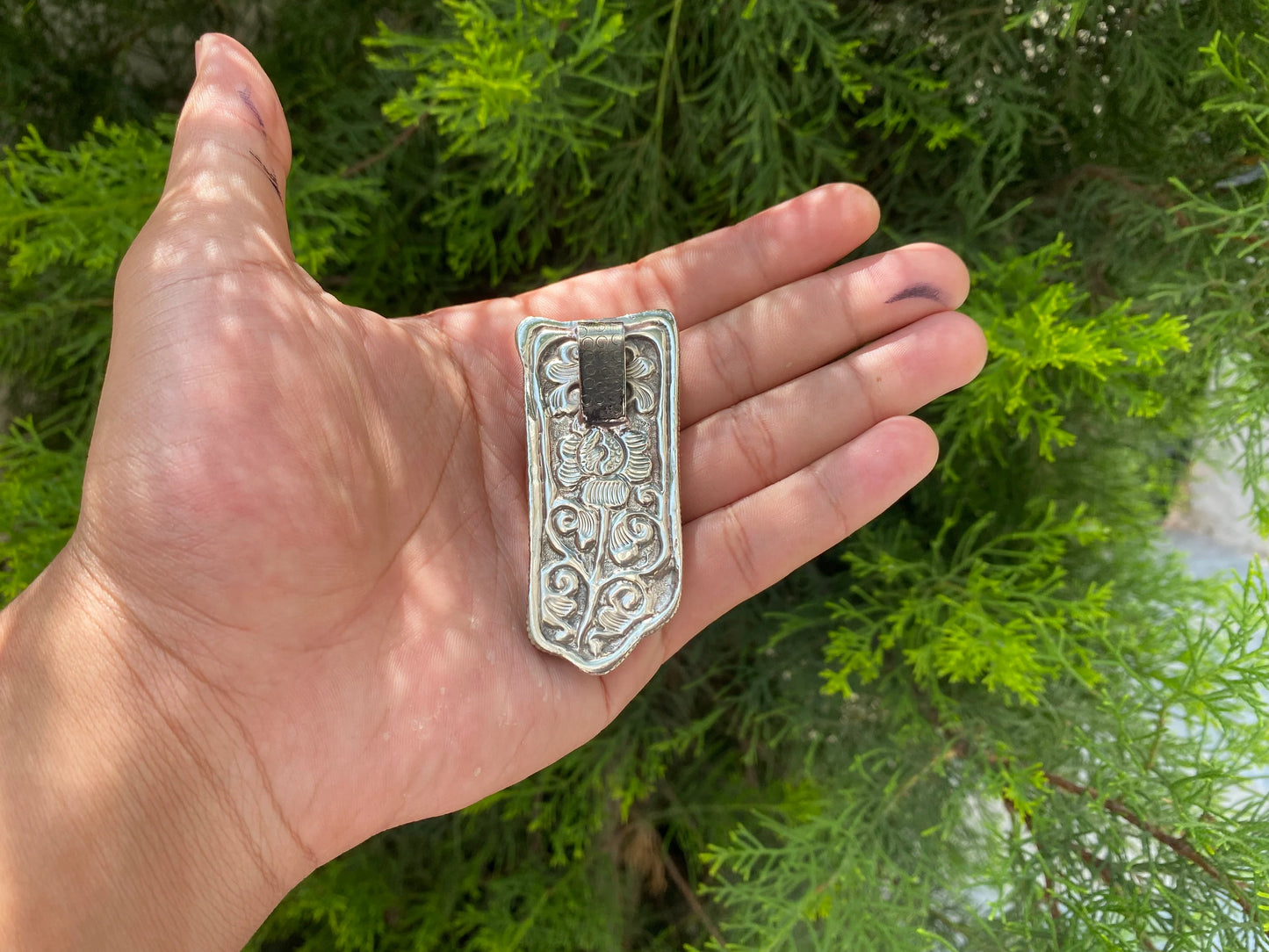 Silver Blossoms: Floral Tibetan Silver Pendant, Tibetan Silver Pendant with Floral Motifs.