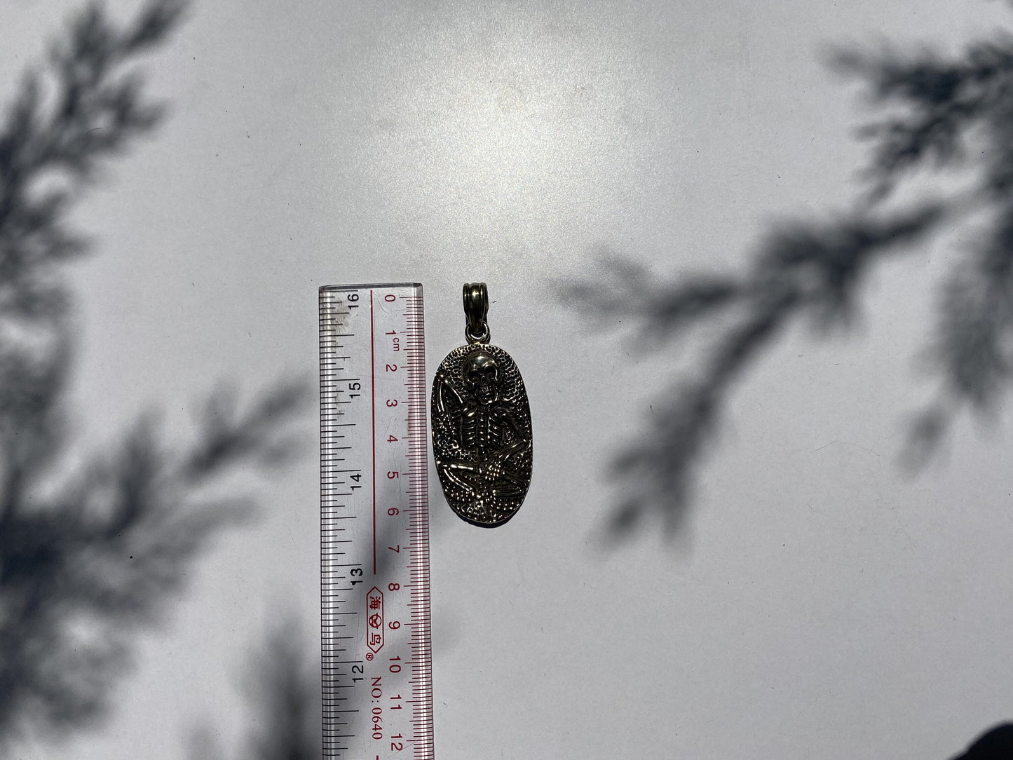 Soul Sentinel: Carved Skull on Tibetan Silver Amulet, Carved Skull Amulet in Tibetan Silver.