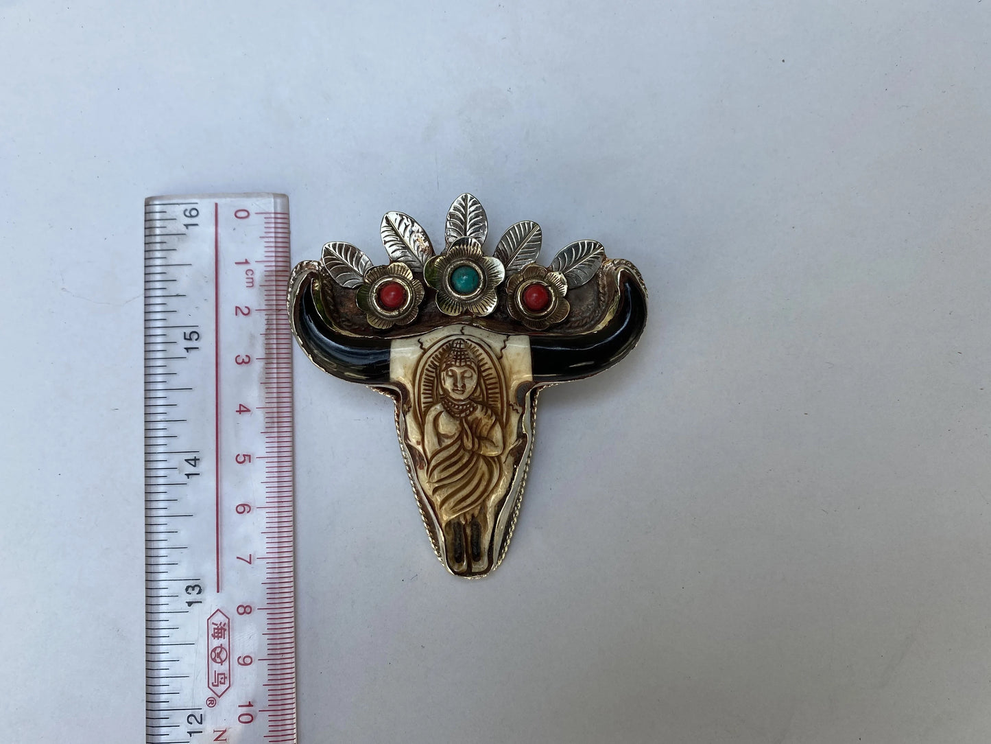 Unique Tibetan Silver Longhorn Bull Pendant with Intricate Buddha Carving with added turquoise and coral.