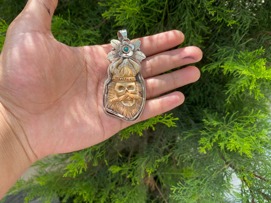 Ancient Strength: Tribal Barbarian Head Carved Tibetan Silver Pendant in Water Buffalo Bone and added Turquoise.