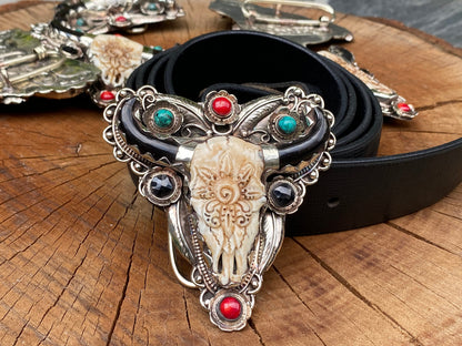 Bulls head shaped Tibetan Silver Belt Buckle adorned with Natural Turquoise, Red Coral, Black Onyx. Floral Design carved on buffalo bone.