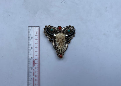 Bulls head shaped Tibetan Silver Belt Buckle adorned with Natural Turquoise, Red Coral, Black Onyx. Floral Design carved on buffalo bone.