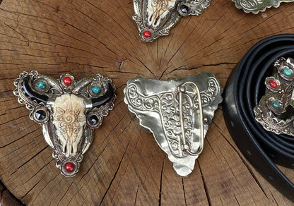 Bulls head shaped Tibetan Silver Belt Buckle adorned with Natural Turquoise, Red Coral, Black Onyx. Floral Design carved on buffalo bone.