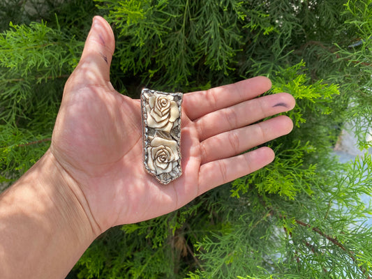 Silver Blossoms: Floral Tibetan Silver Pendant, Tibetan Silver Pendant with Floral Motifs.