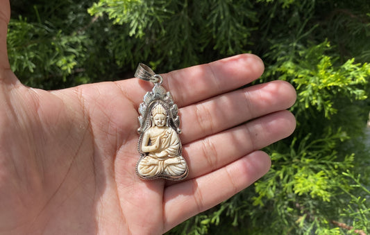 Harmony and Heritage: Buddha on Buffalo Bone with Tibetan Silver Surround, Buddha Carved Buffalo Bone Pendant in Tibetan Silver.