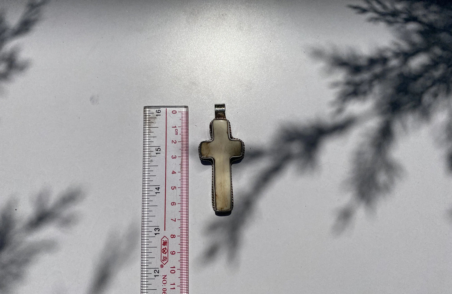 Sacred Harmony: Intricately Carved Buffalo Bone Cross with Tibetan Silver, Buffalo Bone Cross Enhanced with Tibetan Silver.