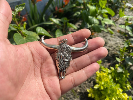 Large Horn Bull with buddha carved inside it symbolizing fertility of the earth and representing  earthly passions, silver pendant.